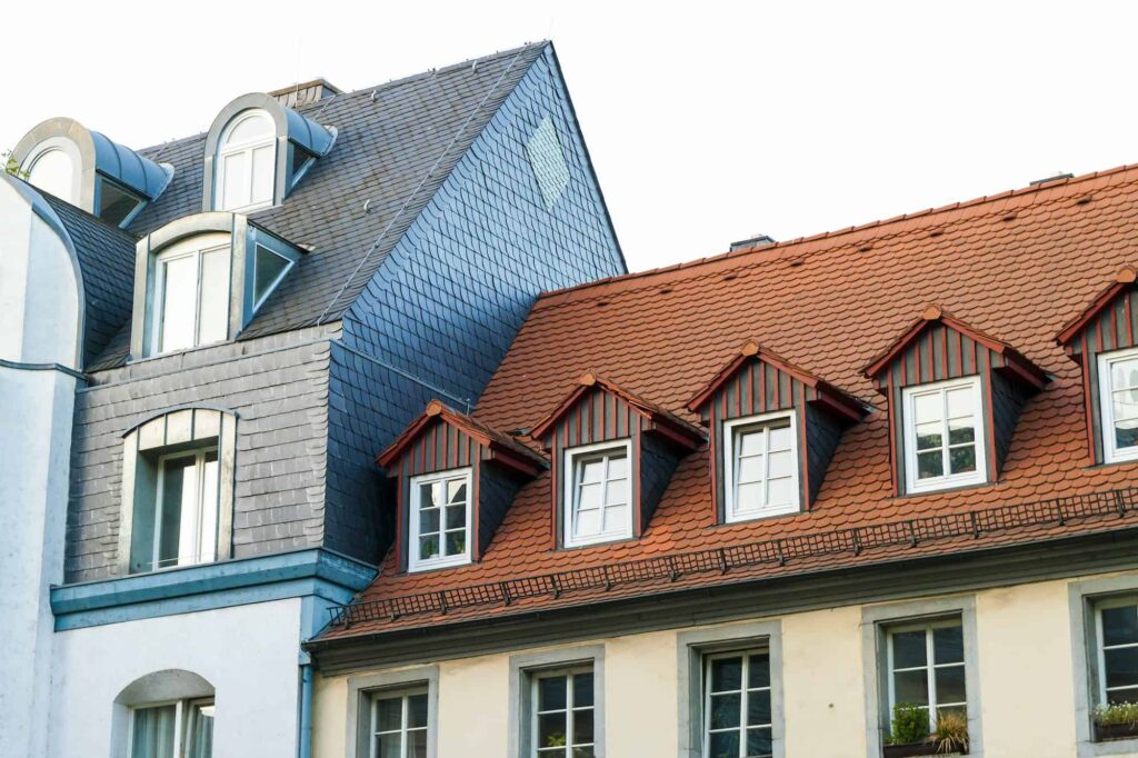 roofs of old houses with roof windows and orange roof tiles in german city